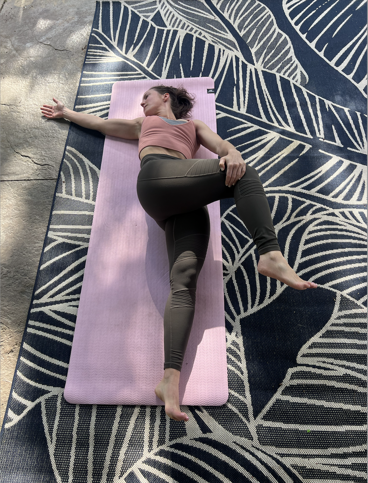 person doing supine twist pose